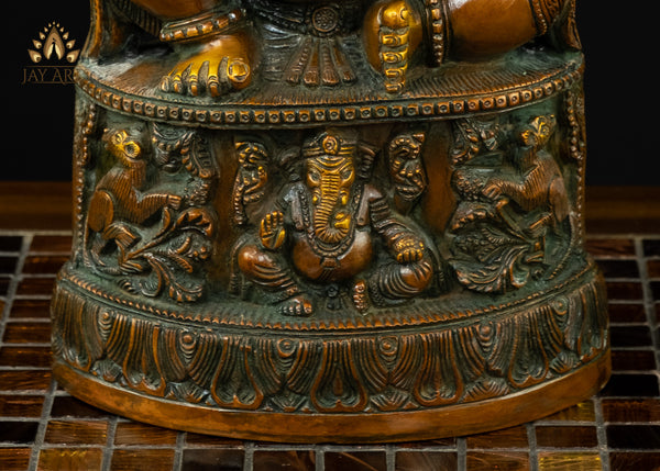 13" Lord Ganesh with Surya Halo seated on a pedestal with figurines of Ganesh and Lakshmi