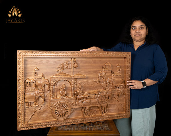 Gita Upadesam 24"H x 38"W - A wood carving depicting the scene of Lord Krishna's teachings to Arjuna