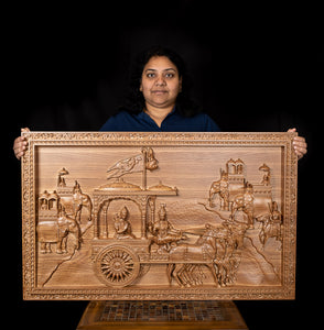 Gita Upadesam - A wood carving depicting the scene of Lord Krishna's teachings to Arjuna