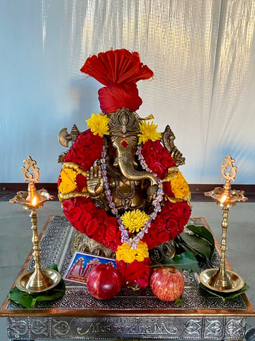 Ashirvadh Ganesh seated on a pedestal engraved with figurines of Himself