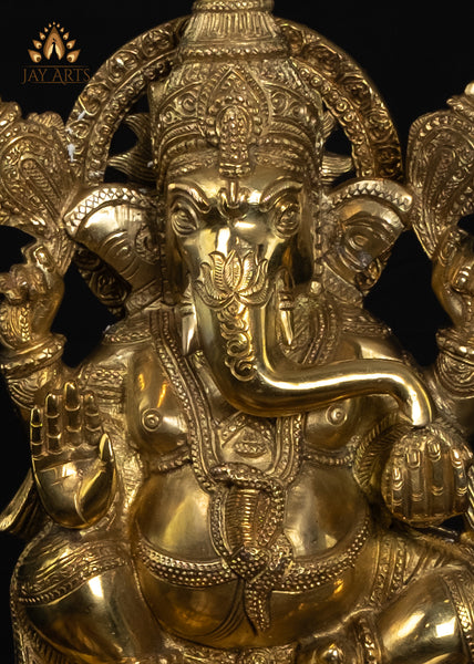 13" Lord Ganesh with Surya Halo seated on a pedestal with figurines of Ganesh and Lakshmi