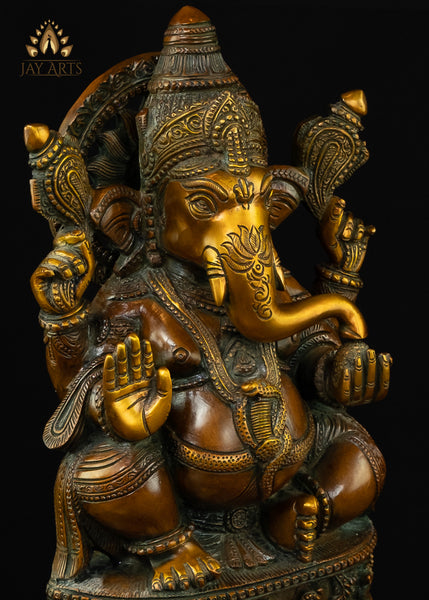 13" Lord Ganesh with Surya Halo seated on a pedestal with figurines of Ganesh and Lakshmi