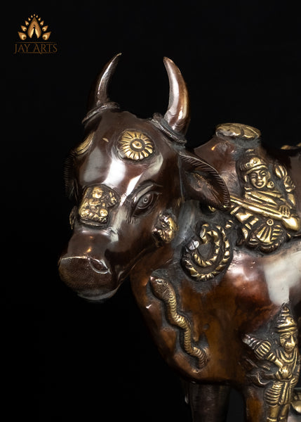 Brass Kamadhenu Cow Statue with Hindu Deity Engravings on Hand-Shaped Pedestal 17"