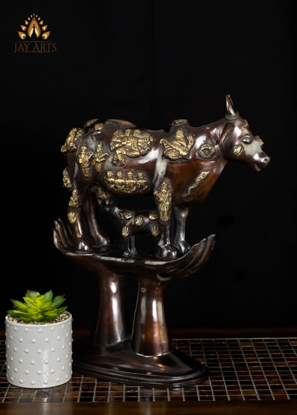 Brass Kamadhenu Cow Statue with Hindu Deity Engravings on Hand-Shaped Pedestal 17"