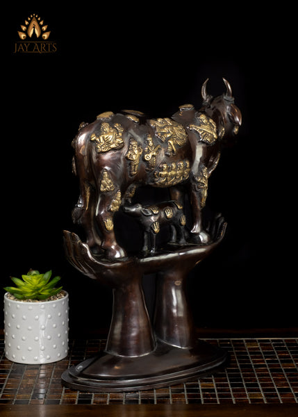 Brass Kamadhenu Cow Statue with Hindu Deity Engravings on Hand-Shaped Pedestal 17"