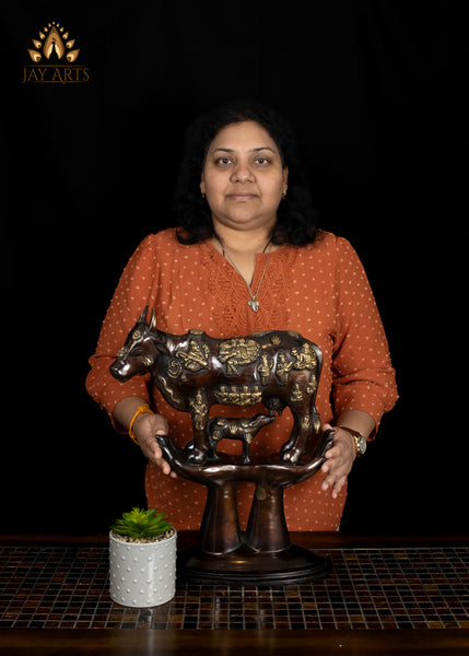 Brass Kamadhenu Cow Statue with Hindu Deity Engravings on Hand-Shaped Pedestal 17"