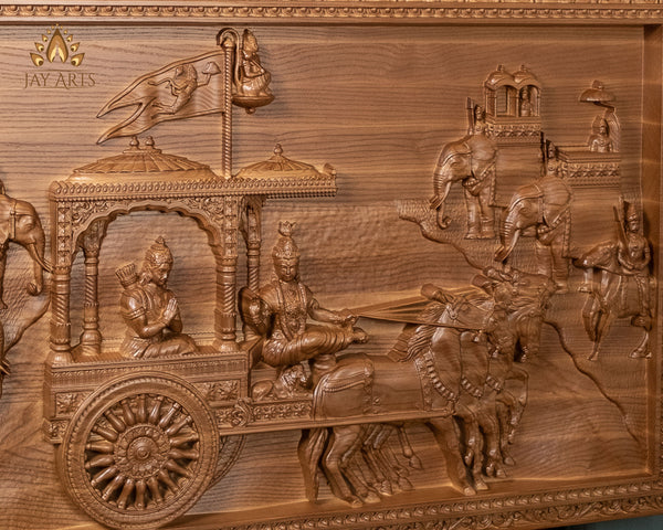 Gita Upadesam 24"H x 38"W - A wood carving depicting the scene of Lord Krishna's teachings to Arjuna