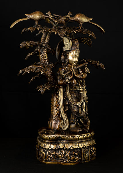 Sri Krishna playing his flute under the canopy of a Kadamba tree