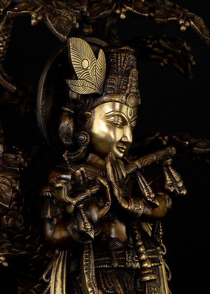 Sri Krishna playing his flute under the canopy of a Kadamba tree