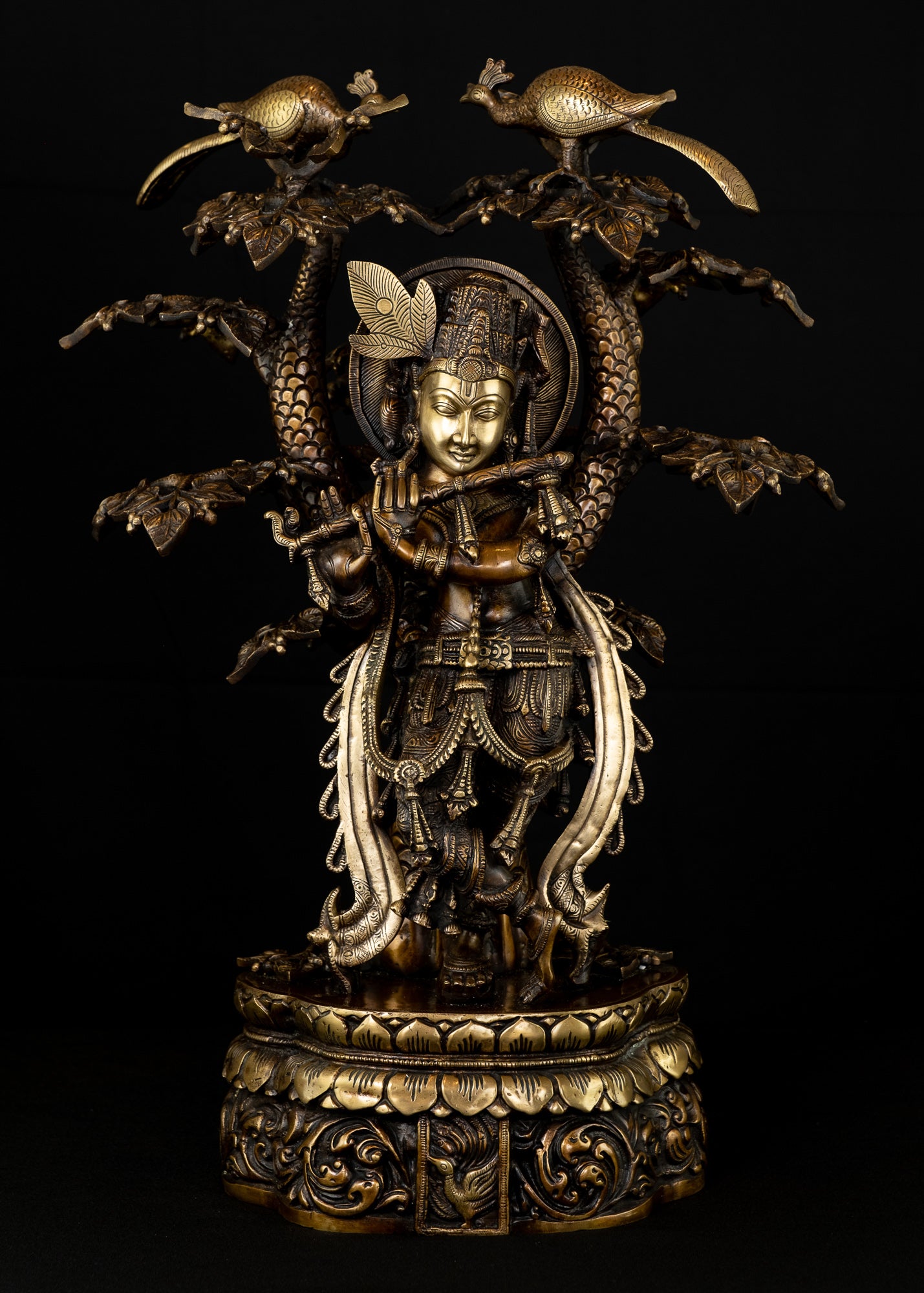 Sri Krishna playing his flute under the canopy of a Kadamba tree
