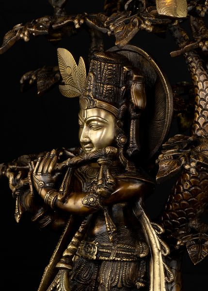 Sri Krishna playing his flute under the canopy of a Kadamba tree