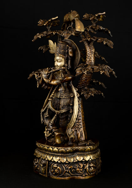 Sri Krishna playing his flute under the canopy of a Kadamba tree