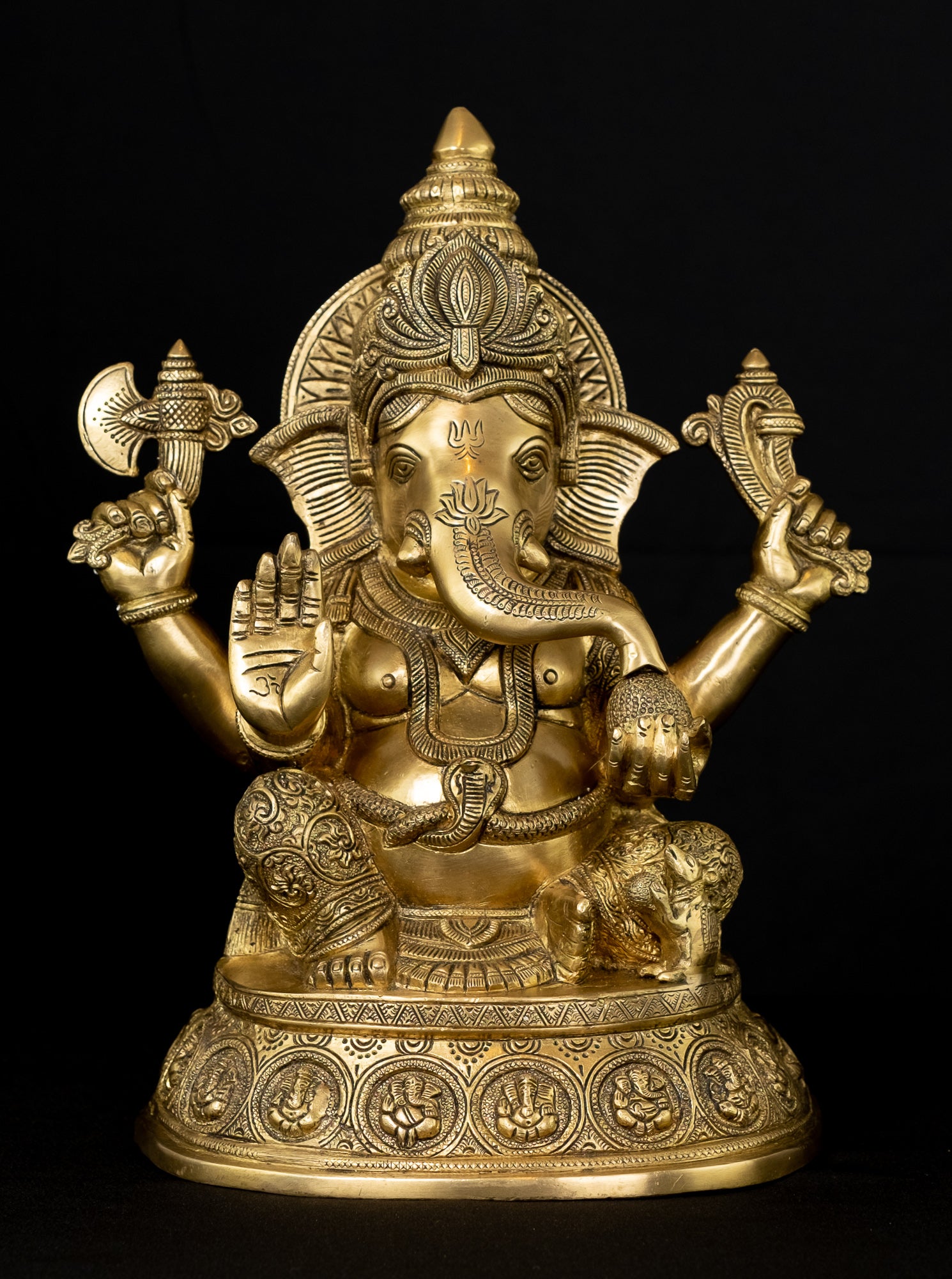 Ashirvadh Ganesh seated on a pedestal engraved with figurines of Himself