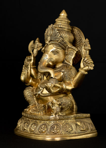 Ashirvadh Ganesh seated on a pedestal engraved with figurines of Himself