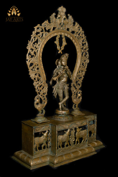 Bronze Sri Krishna Standing on a Cow Engraved Base with a Peacock Arch 44" - Lost-Wax Method Sculpture