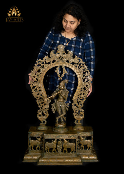 Bronze Sri Krishna Standing on a Cow Engraved Base with a Peacock Arch 44" - Lost-Wax Method Sculpture